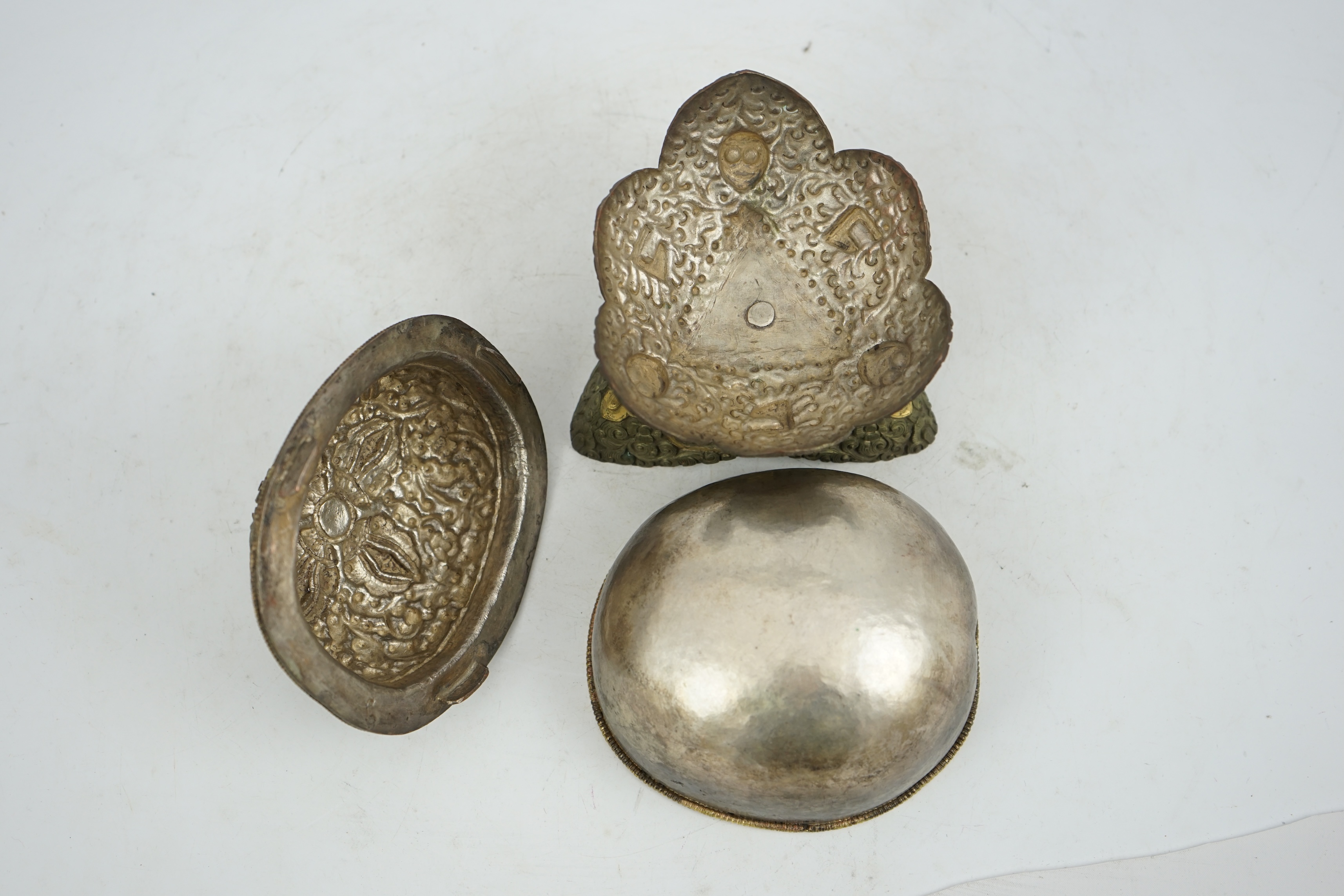 A Tibetan silvered and gilt repoussé copper and bronze capala bowl, late 19th/early 20th century